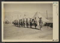 [recto] Manzanar, Calif.--Army military police go on duty to guard the boundaries of this War Relocation Authority center for evacuees of Japanese ancestry. ;  Photographer: Albers, Clem ;  Manzanar, California.